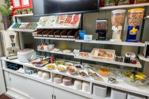 a display case in a restaurant filled with food at Sejour Inn Nagarekawa in Hiroshima