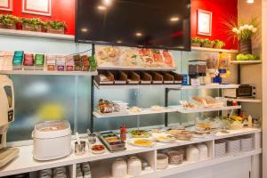 a kitchen with a buffet of food on display at Sejour Inn Nagarekawa in Hiroshima