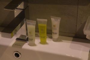 three tubes of sunscreen sitting on top of a sink at City Hotel Colombo 02 in Colombo