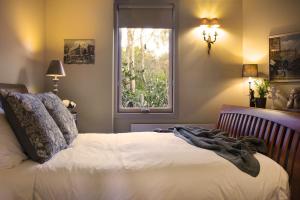a bedroom with a bed and a window at Kookaburra Ridge in Hepburn