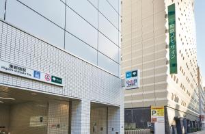 a building with a parking meter in front of it at Sotetsu Fresa Inn Higashi Shinjuku in Tokyo