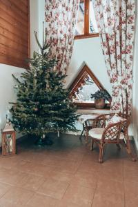 a christmas tree in a room with a table and chairs at Chata u Bronka in Białka Tatrzańska +161 photos