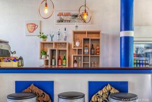 a bar with a blue counter and stools at Hotel Kata Hill Sea View in Kata Beach