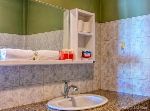 a bathroom with a sink and a mirror at Hotel Kata Hill Sea View in Kata Beach