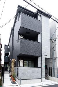 a black and white building with a window at Osaka SAYURI Guesthouse - S&S ABENO 101 in Osaka