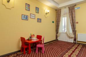 a dining room with a table and chairs and a window at Petrovsky Hotel in Kamensk-Shakhtinskiy