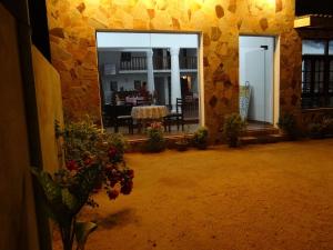 a courtyard with a table and a dining room at New Rani Inn in Negombo