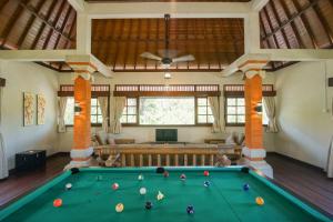 a billiard room with a pool table in a house at Baliana Villa Legian in Legian +54 photos