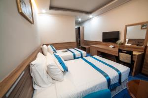 Postel nebo postele na pokoji v ubytování Rum Vang Hotel Da Lat