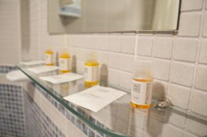 a glass counter in a bathroom with three bottles on it at Hotel Manantiales in Torremolinos