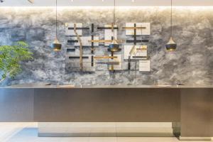 a dining room with a table and a wall at Hotel M's Plus Shijo Omiya in Kyoto