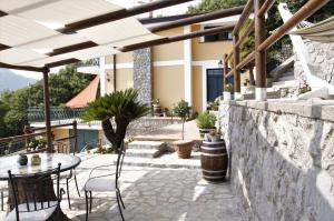 a patio with a table and chairs and a building at B&B Villa Reginella in Agerola