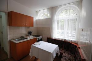 a small kitchen with a table and a window at Geopark Vendégház in Bükkszentkereszt