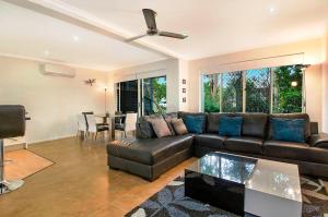 a living room filled with furniture and a couch at Ivory Palms Resort Noosa in Noosaville