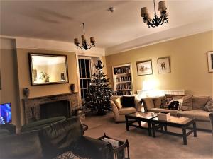 a living room with a christmas tree in it at Lowbyer Manor Country House in Alston