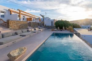 a swimming pool in the middle of a house at Aelia Mykonos in Ornos