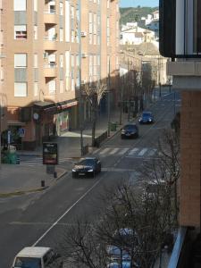 a street with cars driving down a city street with buildings at Apartamento Maravillas in Caravaca de la Cruz