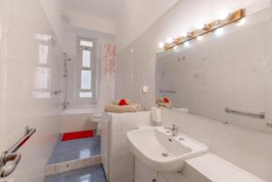 a white bathroom with a sink and a toilet at Alessia's Flat- Loreto 2 in Milan