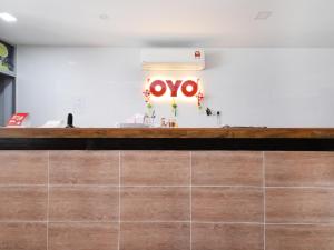 a restaurant with a wooden counter with aoya sign on the wall at OYO 836 Mandurah Room & Cafe in Kuching