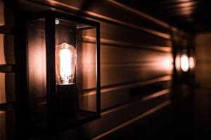 a light fixture hanging on a wall in a room at Hotel Aakenus in Rovaniemi