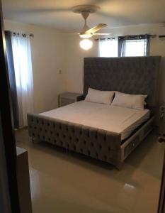a bedroom with a large bed with a large headboard at Total New!! Exclusive!! Apt At Paradise V .. in Santo Domingo