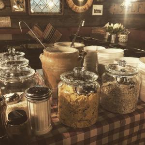 a table topped with jars of food on a table at Den Röda Båten in Stockholm
