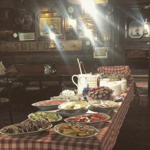 a table topped with plates of food and drinks at Den Röda Båten in Stockholm