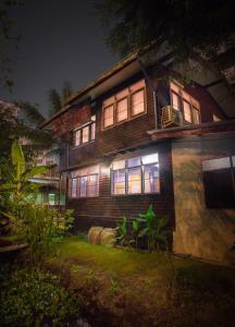 a wooden house with lights on in the yard at Yesterday Sathon in Bangkok +21 photos