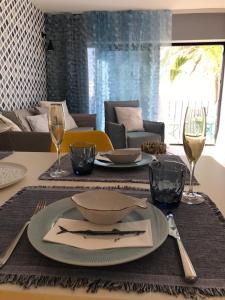 a dining room table with a plate and wine glasses at Boutique-Apartment in San Agustin in San Agustin