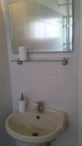 a bathroom with a sink with a mirror and a mirror at LIRA in Larnaka