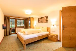 ein Hotelzimmer mit einem Bett und einem Fenster in der Unterkunft Appartements Schrambacherhof in Achenkirch