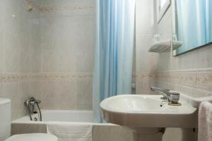 a bathroom with a sink and a toilet and a shower at Apartamentos Maria - Formentera Vacaciones in Es Pujols +12 photos