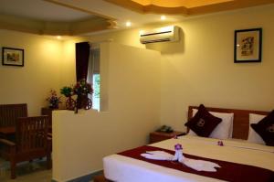 Giường trong phòng chung tại Thao Ha Mui Ne Hotel