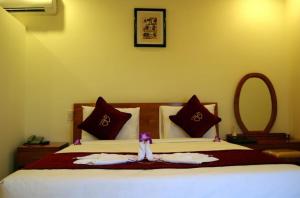 Ліжко або ліжка в номері Thao Ha Mui Ne Hotel
