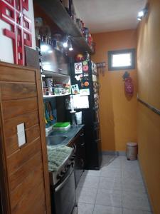 a small kitchen with a stove and a sink at Hermoso departamento para viajeros in San Fernando