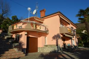 a pink building with a balcony on top of it at Apartment Valentina in Opatija