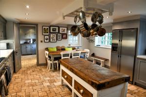 a kitchen with a table and a dining room at Country chic in unique English village in Nun Monkton