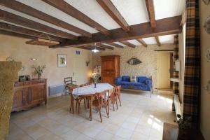 a living room with a table and a blue couch at La Jariette in Airvault