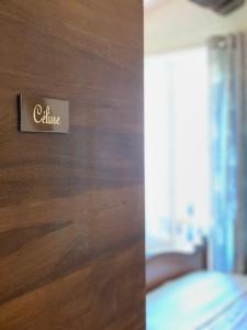 a close up of a door with a hotel sign on it at La Clé de la Porte B&B in Antibes