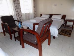 Uma cama ou camas num quarto em Ranges View Lodge Staycation