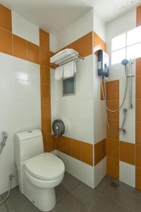 a bathroom with a toilet and a shower at Kulasub Hotel in Hat Yai