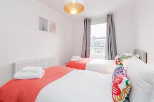 a bedroom with two beds and a window at WelcomeStay Clapham Junction 2 Bedroom Apartment in London