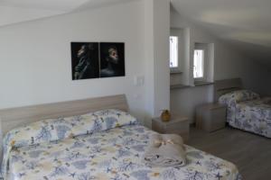 a bedroom with a bed with a bedspread on it at M@re Nostrum & Co. in Campora San Giovanni