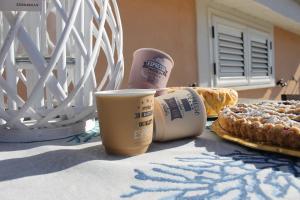 a table with a cup of coffee and some bread at M@re Nostrum & Co. in Campora San Giovanni