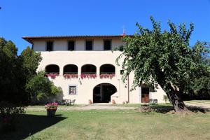a large white building with a tree in front of it at Antico Borgo La Torre Agriturismo in Reggello