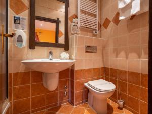 a bathroom with a sink and a toilet at Stupnički Dvori Winery Hotel in Brodski Stupnik