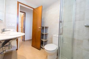 a bathroom with a toilet and a sink and a shower at HomeHolidaysRentals Bonte in Malgrat de Mar +27 photos