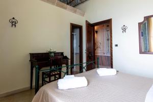 a bedroom with a bed with two towels on it at B&B La Riviera in Gallipoli +36 photos
