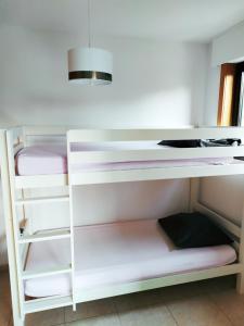 a white bunk bed in a room at Maison familiale tout confort avec garage in Lompret