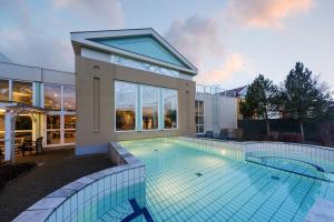 a swimming pool in front of a house at Center Parcs Sauerland Winterberg-Medebach in Medebach